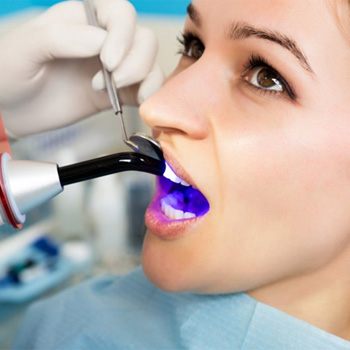 cosmetic dentist in Wylie providing dental bonding to a patient 