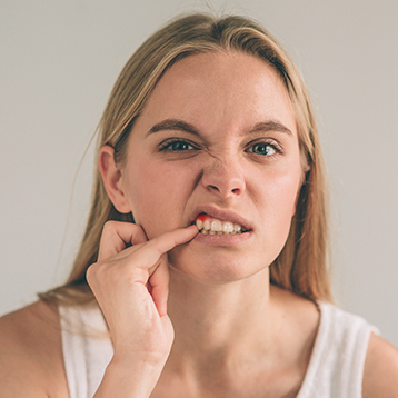 Woman with irritated gum tissue